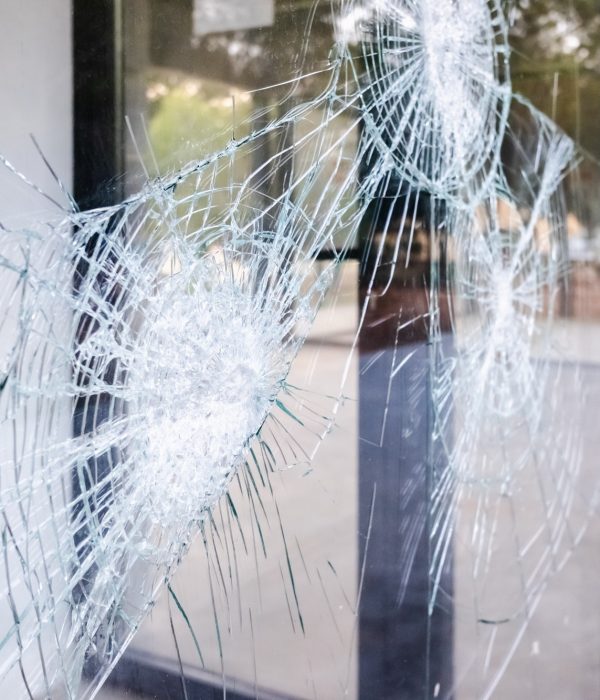 Glass of a broken and cracked commercial showcase.